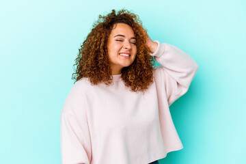 Fototapeta premium Young latin curvy woman isolated on blue background joyful laughing a lot. Happiness concept.