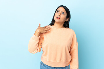 Young latin woman woman isolated on blue background with tired and sick expression