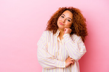 Young latin curvy woman isolated on pink background who feels sad and pensive, looking at copy space.