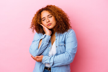 Young latin curvy woman isolated on pink background who is bored, fatigued and need a relax day.