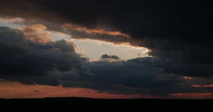 Gloomy clouds at sunset, stormy. Timelapse.