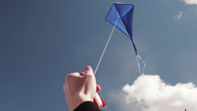 A blue kite soars in the sky. The concept of freedom, summer hobbies, entertainment in nature. Minimalism, space for text, shades of blue.	
