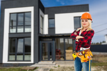 Happy woman on the background of a new house. Portrait of first time buyer, house owner, apartment renter, flat tenant or landlady. Moving day and buying own property concept