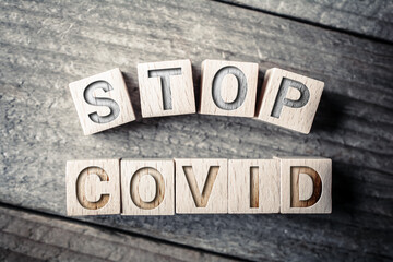 Stop Covid Written On Wooden Blocks On A Board