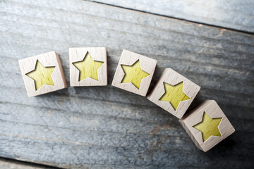 Curved 5 Star Ranking Formed By Wooden Blocks On A Board - Top Performance Concept