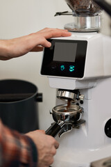 Barista using a coffee machine to make coffee