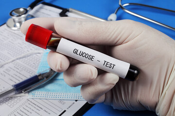 Glucose test , vacuum tube with blood in the doctor's hand, selective focus, close-up.