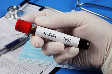 Alcohol test , vacuum tube with blood in the doctor's hand, selective focus, close-up.