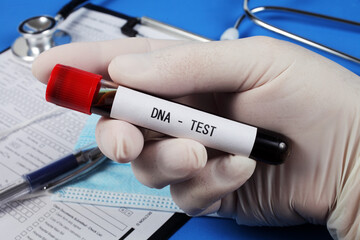 DNA  test , vacuum tube with blood in the doctor's hand, selective focus, close-up.