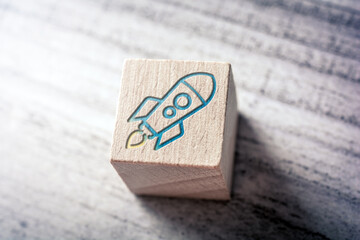 Rocket On A Wooden Block On A Table - Business And Strategy Success Concept