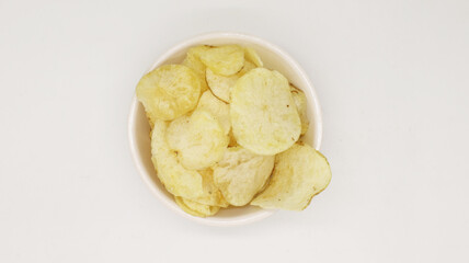 Potato chips on bowl isolated on white background