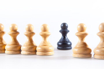Black and white chess pieces on the white background