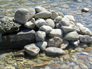 Fototapeta na wymiar a pile of stones in a river 