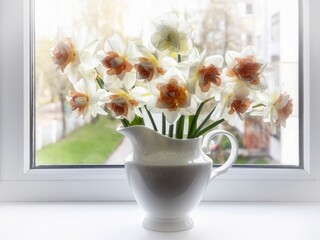 Still life with bouquet of narcissus on a windowsill
