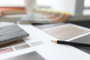 Catalog with samples of wood flooring is on table