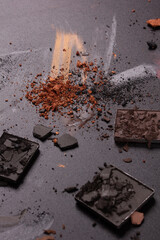 Colorful photo with various cosmetic products on a dark background