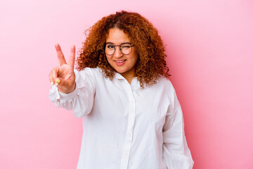 Young latin curvy woman isolated on pink background showing number two with fingers.