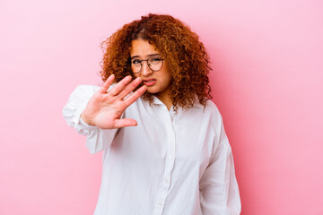 Young latin curvy woman isolated on pink background rejecting someone showing a gesture of disgust.