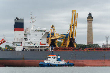 Naklejka premium MARITIME TRANSPORT - Merchant vessel in seaport