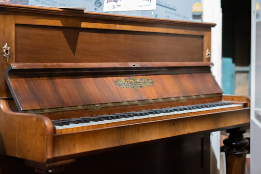 Aldershot, UK - 5th September 2020: Henry Ward wooden grand piano, vintage old on display in museum in Aldershot, UK