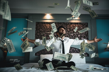 Successful businessmen celebrates success under money rain falling down dollar bills . Finances...
