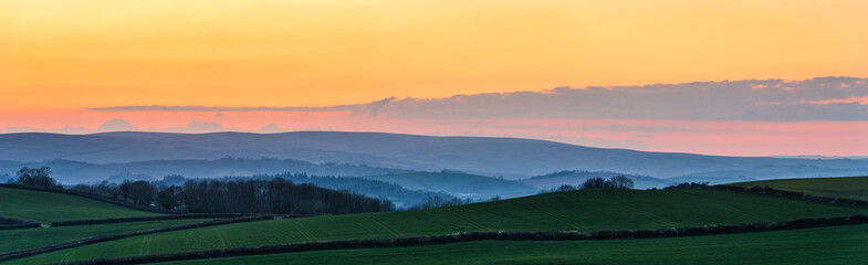 Fototapeta na wymiar Sunset over Totnes fields, Berry Pomeroy Village, Devon, England, Europe