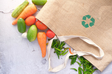 Recycled arrows sign on a shopping bag with vegetable 