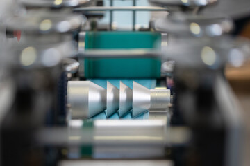 Closeup process of medical face masks being made in a factory. Automated machinery making respiratory medical masks in large quantities.