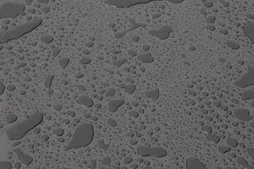 Large drops of water on plastic film after rain