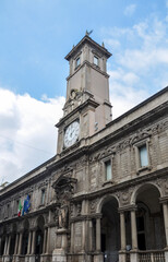 Fototapeta na wymiar The Giureconsulti palace congress center of Chamber of Commerce with clock tower on Mercanti square near Duomo square in Milan city center, Italy