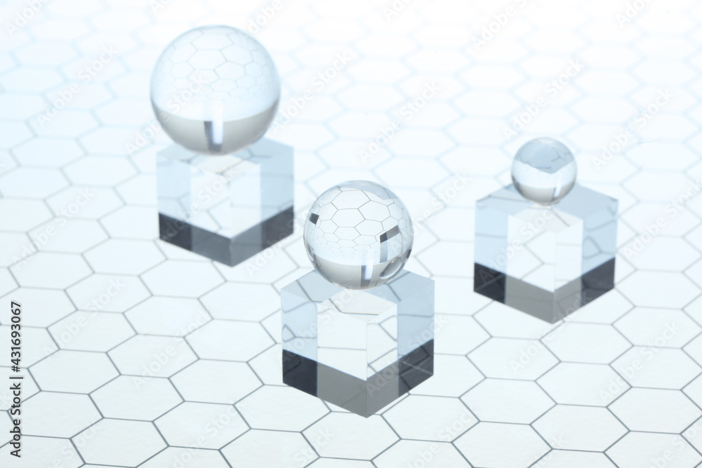 Poster transparent ball shpere rest on tramsparents plexiglass cube on an honeycomb glass pattern with copy