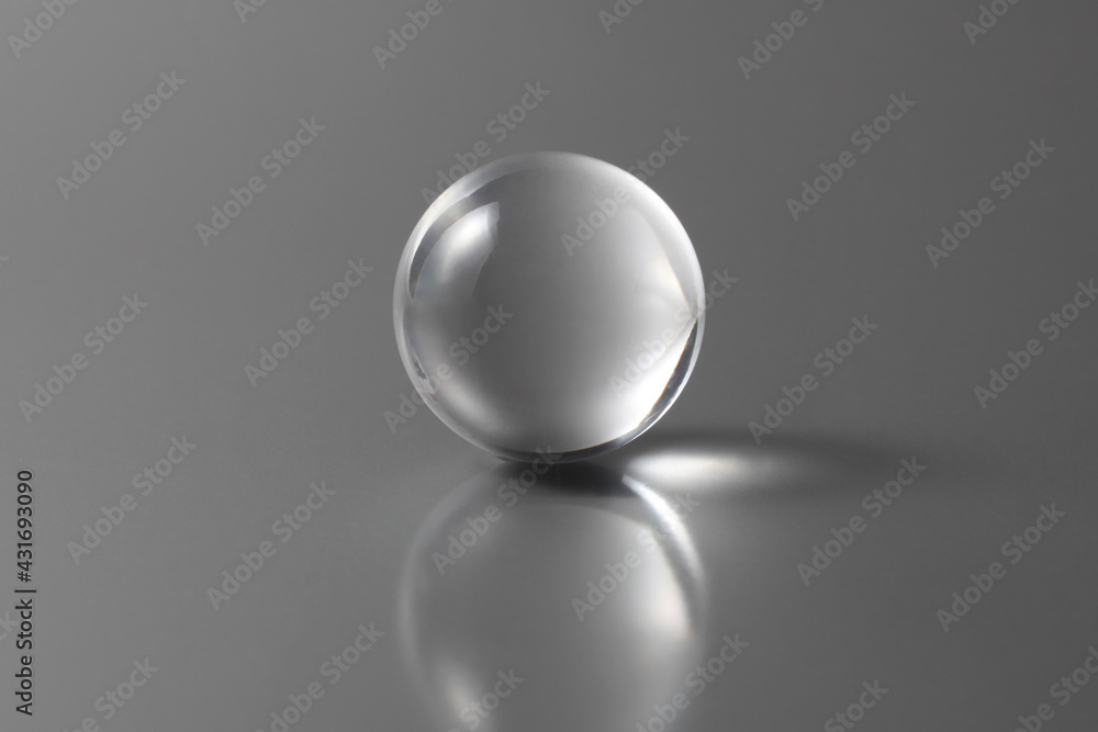Fototapete tranparent ball on a grey background with copy space for your text