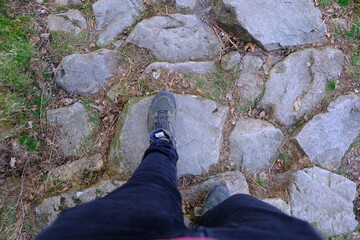 Green walking boots on stone path