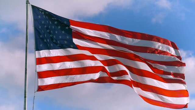 American flag waving in wind, slow motion video footage Realistic USA Flag. Waving American Flag Background. American Flag Closeup. National Patriotism And Celebration With Banner Flying. USA concept.
