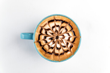 Isolated blue cup of fresh brewed coffee with art on the white
