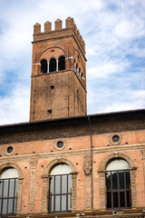 The medieval Arengo Tower and the Palazzo del Podesta, ancient palace in in Renaissance style (1200 - XV century) in Piazza Maggiore, main square in Bologna downtown, Emilia Romagna, Italy, Europe.