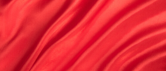 Abstract red silk fabric texture background. Cloth soft wave. Creases of satin