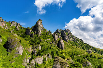 Beautiful rocky mountain landscape with green grass and blue sky, Ciucas Mountains, Romania