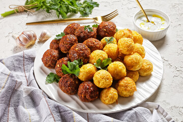 Meatballs and spaghetti balls on a plate, close-up