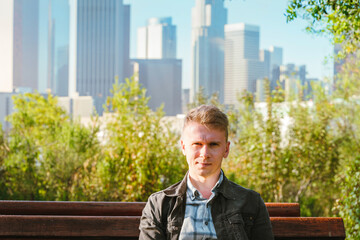 Portrait of a young business man with a view of Downtown skyscrapers in Los Angeles