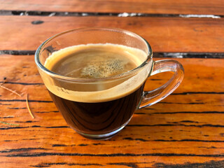 Black coffee on the beachside table, nature light. Thailand