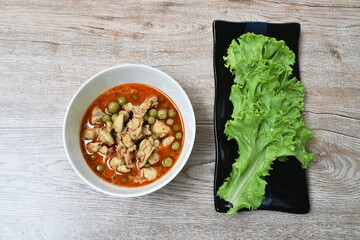 spicy boiled chicken with eggplant in coconut milk curry soup on bowl
