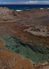 Gran Canaria, calm natural seawater pools in under the steep cliffs of the north coast, separated from the ocean by 
volcanic rock, Punta de Galdar area