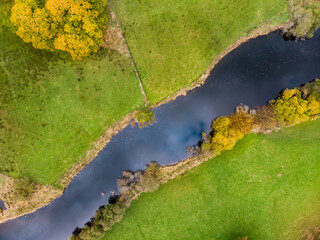 Aerial top down view of small river in the Lake District, famous for its glacial ribbon lakes and rugged mountains. Popular vacation destination in Cumbria, UK
