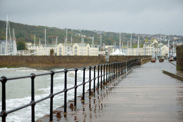 Waves crashing into pier of Whitehaven harbour in Cumbria, England, UK.