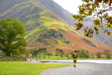 Fototapeta premium Tourist exploring Buttermere lake, located in the Lake District, Cumbria, UK.
