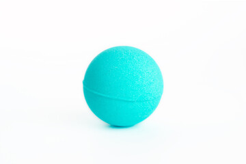 Blue bubbling round bright bath bomb in the shape of a ball  isolated on a white background....