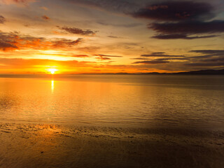 Obraz premium Beautiful sunset colors over the coastline of Allerdale district in Cumbria, UK. Sun setting over the shore of Allonby bay on autumn.