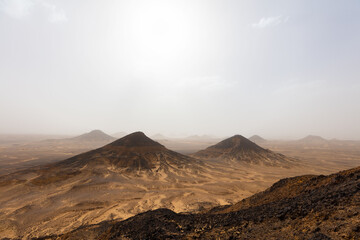 Fototapeta na wymiar Landscape of the Black Desert with clear sky on the background.