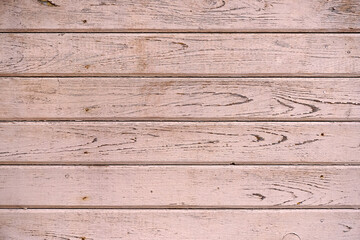 Wall texture upholstered with old painted pink pine boards
